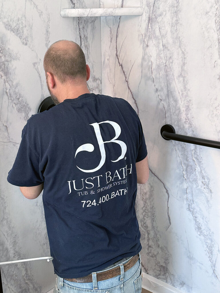 Your Big Bathroom Conversions Guide 2 A Just Bath installer works on a bathroom conversions project installing the new finishes.
